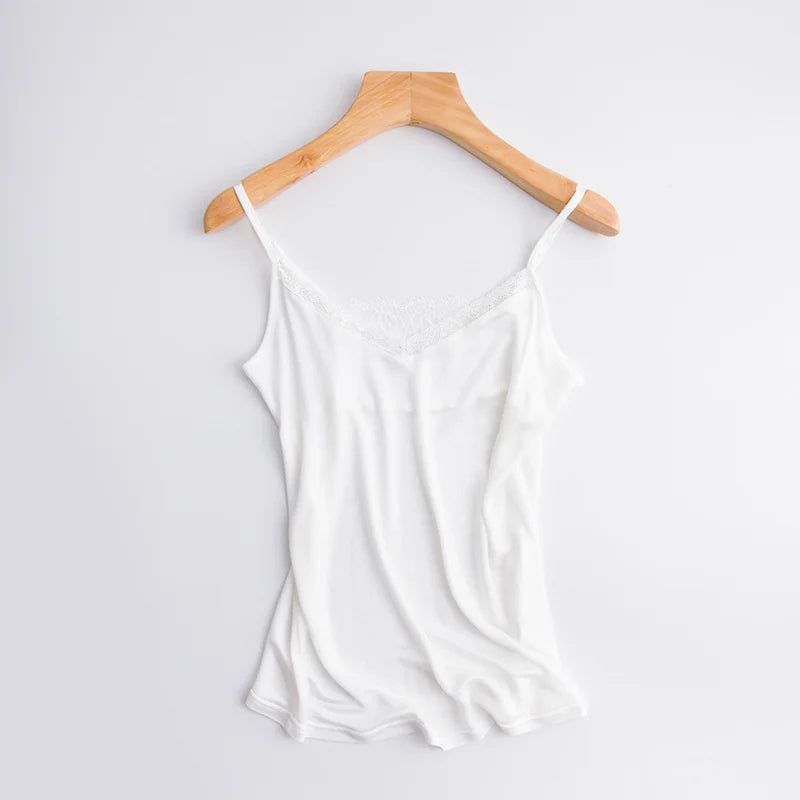 LuxeLace™ silk camisole tank top in white, sleeveless with lace detail, showcased on a wooden hanger.