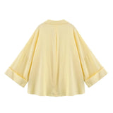 Back view of WideLine™ oversized yellow striped shirt with loose fit and wide sleeves for summer casual wear.
