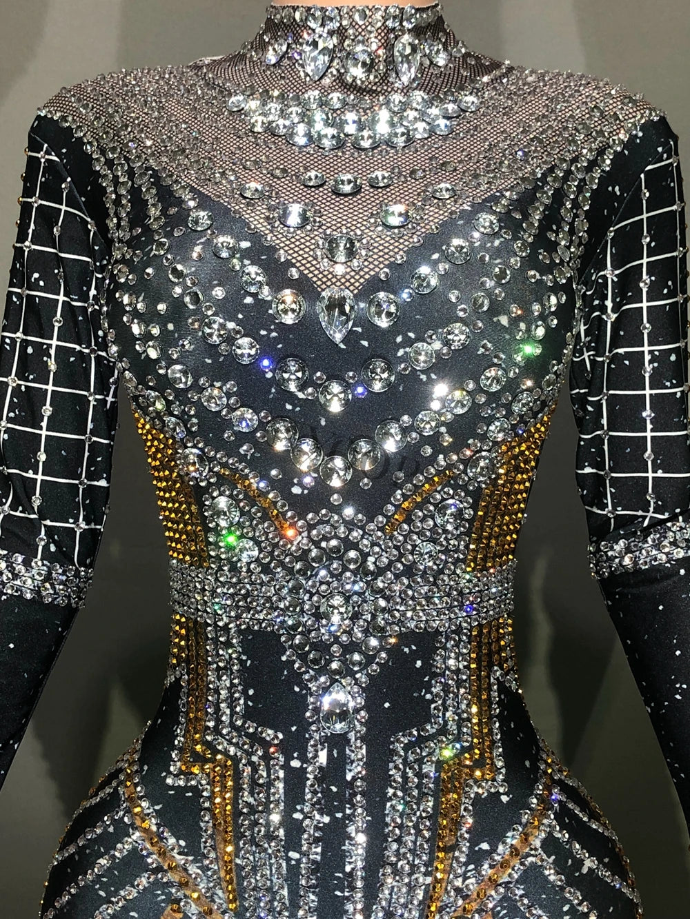 Rhinestone jumpsuit featuring an intricate design, perfect for stage performances and nightclubs, made of polyester and spandex.