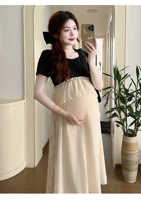 Pregnant woman in a stylish short sleeve maternity dress, showcasing a casual summer look with a beautiful design.
