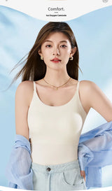 Model wearing BraChic™ Ice Silk Cami in cream, showcasing built-in bra and comfort features.