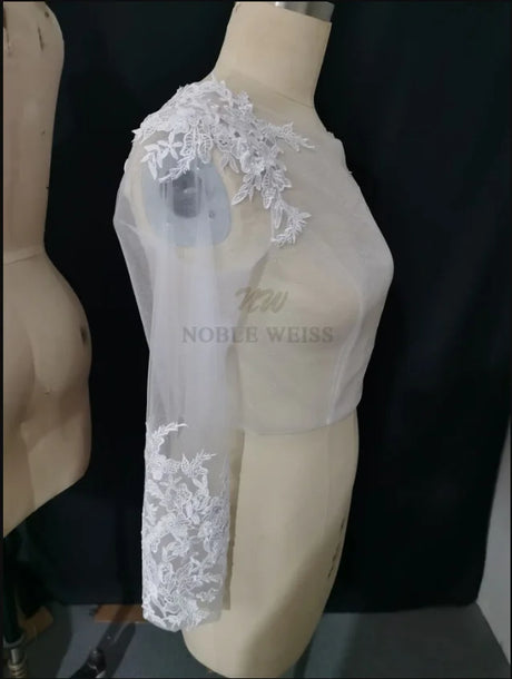 Lace Bridal Bolero with long sleeve appliques, elegant sheer design for brides, crafted by Noble Weiss.
