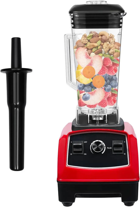 Countertop smoothie blender with stainless steel blades, red base, and fruit ingredients ready for blending.