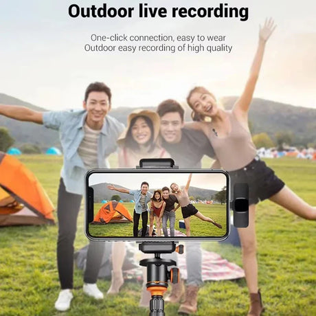 Group of friends enjoying outdoor live recording with a smartphone on a tripod, showcasing a fun camping moment.
