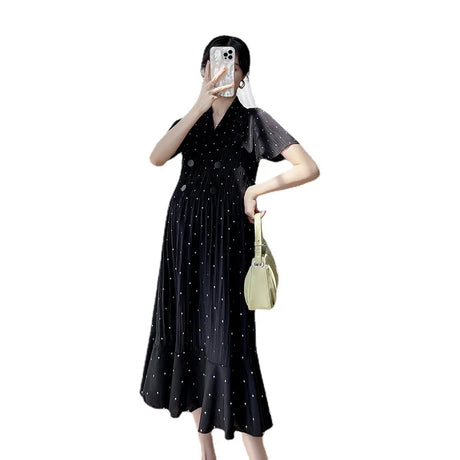 Black polka dot maternity dress with short sleeves and high waist, perfect for summer wear.
