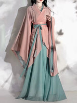 Model wearing a pink and green Hanfu vintage cosplay costume with flowing sleeves, showcasing traditional Chinese attire.