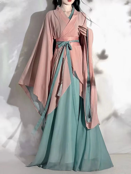 Model wearing a pink and green Hanfu vintage cosplay costume with flowing sleeves, showcasing traditional Chinese attire.