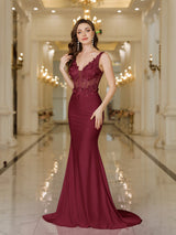 Elegant burgundy gown with lace details, fitted silhouette, and mermaid design, perfect for formal events.