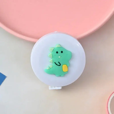 Cute green dinosaur height ruler with smiling expression, designed for kids, on a pastel background.