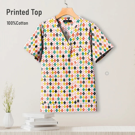 Colorful printed hospital scrub top made of 100% cotton, featuring a V-neck design and pockets for nurses.