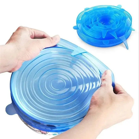 Hands using adjustable blue silicone food cover for airtight sealing of bowls.