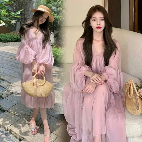 Model wearing a sweet strappy maternity dress in tulle, styled with a straw hat and bag, perfect for summer vacation.
