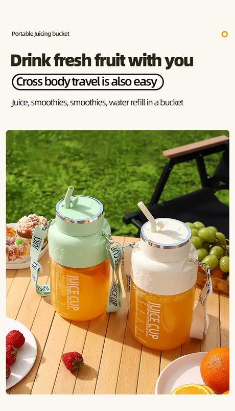 Two portable juicing buckets filled with juice, perfect for smoothies and travel, displayed on a sunny picnic table.