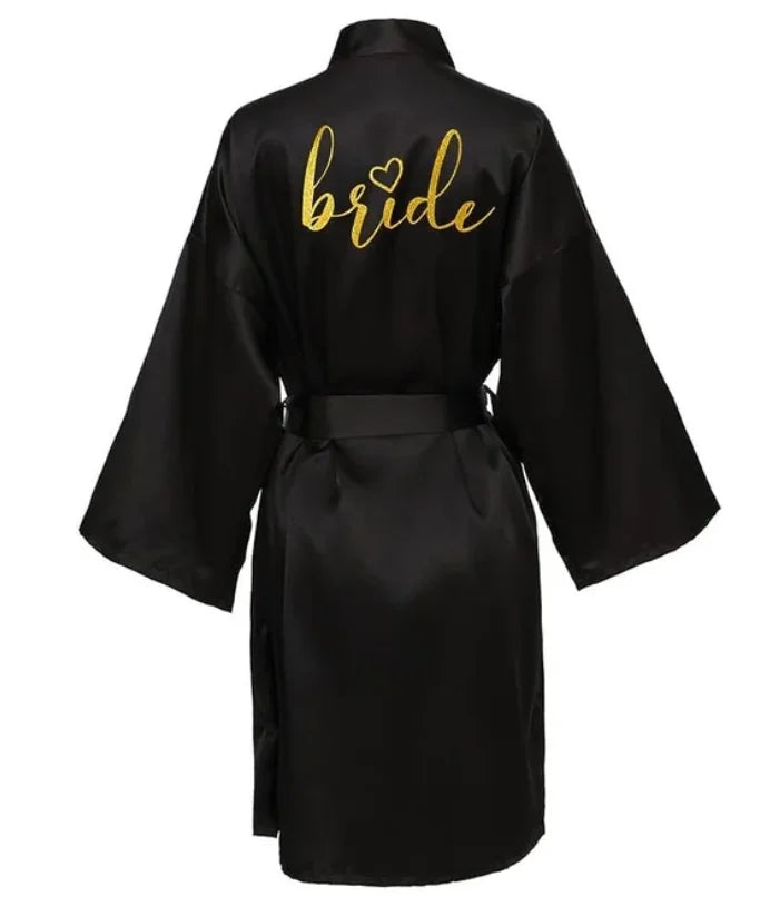 Team Bride satin kimono robe in black with golden 'bride' lettering on the back, ideal for bridal parties.