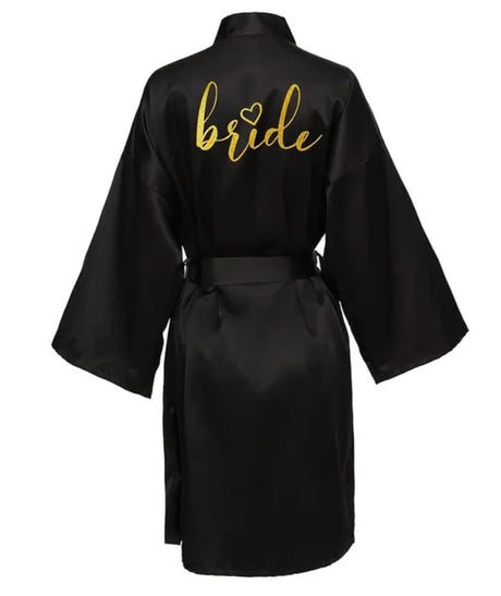 Team Bride satin kimono robe in black with golden 'bride' lettering on the back, ideal for bridal parties.
