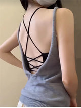 Back view of a young woman wearing a grey CrossForm™ padded tank top with crisscross straps.