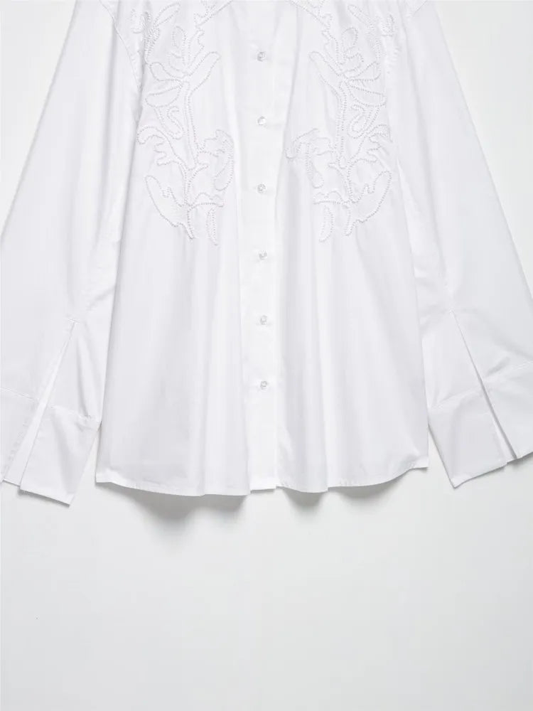 Elegant white embroidery shirt with long sleeves, stand collar, and button closure for casual wear.
