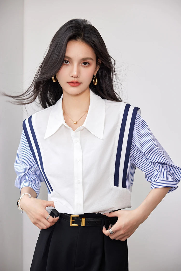Woman wearing a colorblock chiffon shirt with striped sleeves, styled for an office casual look.