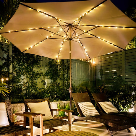 Cordless patio umbrella lights with remote control illuminating outdoor seating at night.