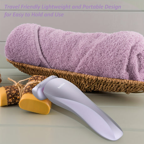 Rechargeable electric shaver for women beside rolled towels, showcasing lightweight and portable design for travel.