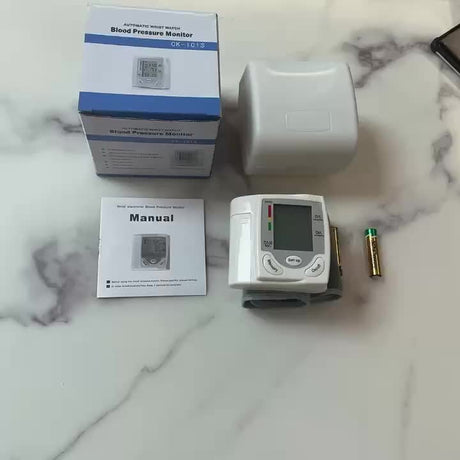 Automatic wrist blood pressure monitor CK-101S with manual and battery, perfect for health monitoring on the go.