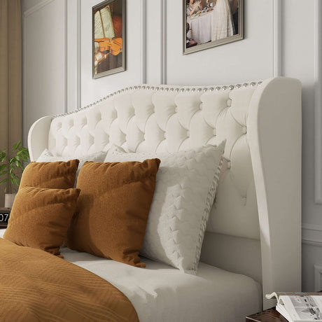 Stylish white tufted bed frame headboard with decorative pillows in contemporary bedroom setting.